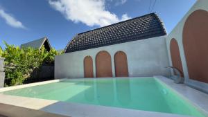a swimming pool in front of a building at Volcano Valley in Kintamani