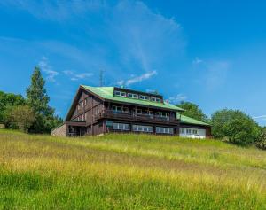 a building on top of a grassy hill at Chata Polárka in Pec pod Sněžkou
