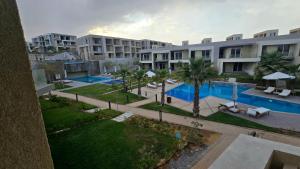 an aerial view of an apartment complex with a swimming pool at boho elsokhna in Ain Sokhna
