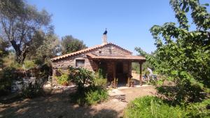 a small house in the middle of a field at Agios Ioannis Solar Cottage - Eco-friendly, Solar Powered in Raches