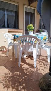 a white table and chairs on a patio at Casa di Silla in Torre del Lago Puccini