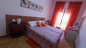 a bedroom with a bed and a window at Casa di Silla in Torre del Lago Puccini