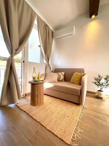 a living room with a couch and a table at Choco's Seaside Studio Apartment in Korčula