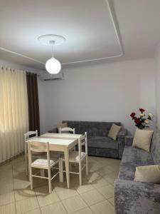 a living room with a table and a couch at Apartment Toska in Berat
