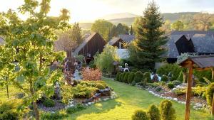 a yard with a garden of plants and trees at Rustic Eden in Liptovský Mikuláš