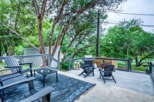 a patio with chairs and a grill and trees at River Access Grill Firepit Sleeps 5 in Kyle