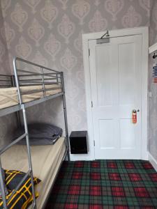 a bedroom with a bunk bed and a white door at IVY House in Edinburgh +20 photos