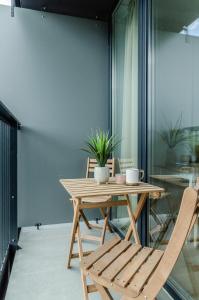 een houten tafel en stoelen in een kamer bij Nemunas A respite Studio 8 in Druskininkai