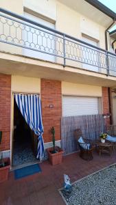 a patio with a blue and white canopy on a house at Casa di Silla in Torre del Lago Puccini