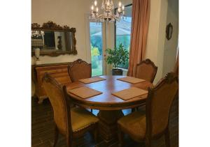 a dining room with a wooden table and chairs at A Luxury Mediterranean Retreat in Spring