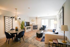 a living room with a couch and a table at Lower Level LuxSuite - 1min Walk from Heated Pool! in Shanty Bay