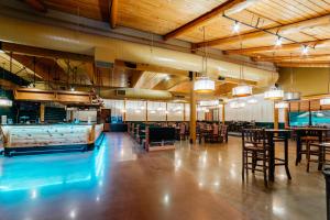 a dining room with tables and chairs and lights at bantr Grand Hotel Wausau - Rothschild in Rothschild