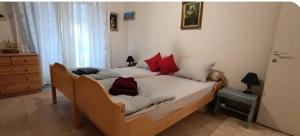 a bedroom with a bed with red pillows on it at Sea view in Nea Peramos +5 photos
