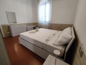 a bedroom with a bed with a dresser and a mirror at Il Porticciolo di Bocca di Magra House in Bocca di Magra
