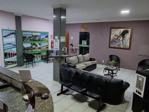 a living room with a couch and a table at Hotel Graciosa Palace in Palmas