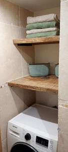 a kitchen with a washing machine on a shelf at Chalet-nature in Bolquere Pyrenees 2000