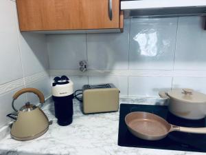 a kitchen counter with a sink and a tea kettle at La Gavina Loft Xàbia & ARCADE in Jávea