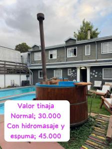 a house with a boat in front of it at Cabaña con tinaja de hidromasaje in Valdivia