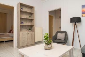 a living room with a table and a chair at Villy Suites in Argasi