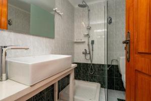 a bathroom with a sink and a shower at Villy Suites - Zante Luxury Suites near the Sea in Argassi +30 photos