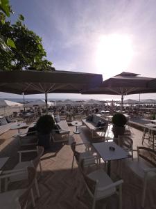 a patio with chairs and tables and umbrellas at Pati's summer house in Siviri