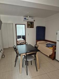 a room with a table and chairs and a bed at pedro de valdivia 219 oeste in San Juan