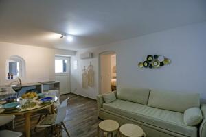 a living room with a couch and a table at Magic Holidays 444 in Mýkonos City +17 photos