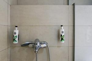 a bathroom with two soap bottles on the wall at Magic Holidays 444 in Mýkonos City