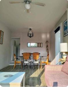 a living room with a table and chairs at jolie Mazet avec piscine privée ! in Nîmes