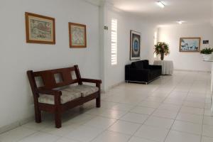 a waiting room with a chair and a couch at Hotel Dom Cláudio in Fortaleza