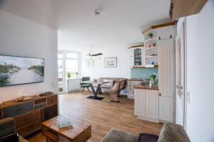a living room with a kitchen and a dining room at Prinz Hamlet Wohnung Pelzi 51 in Pelzerhaken