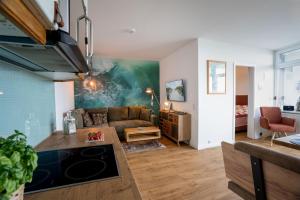 a living room with a couch and a table at Prinz Hamlet Wohnung Pelzi 51 in Pelzerhaken