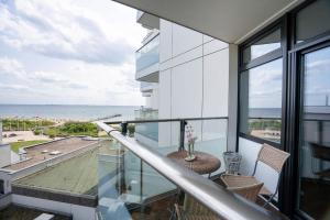 a balcony with a view of the ocean at Prinz Hamlet Wohnung Pelzi 51 in Pelzerhaken
