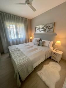 a bedroom with a large bed and a window at S'agaró Mar in Sant Feliu de Guíxols