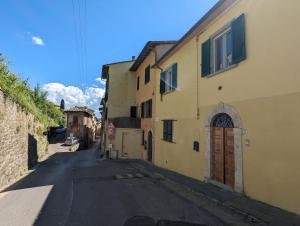 an empty street in an alley with buildings at Beautiful Ceilings in Colle di Val d'Elsa