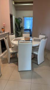 a dining room with a white table and chairs at Wohnen im Beauty Salon- im Herzen von Greven in Greven +29 photos