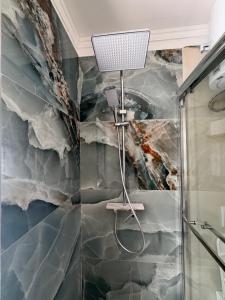 a shower in a bathroom with aamed ceilings at Villa Klinton in Durrës +46 photos