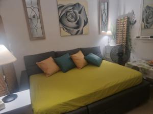 a living room with a couch with a yellow blanket at Apartamento Ura in Morro del Jable