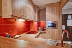 a kitchen with wooden cabinets and a counter top at Casa Riva in Caen
