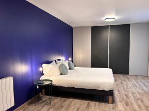 a bedroom with a large bed and a blue wall at Hôtel du Parc Thionville Centre in Thionville +74 photos