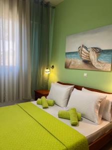 a bedroom with a large bed with yellow and white pillows at Bella Vista in Bali