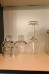 a group of glass glasses sitting on a table at Golf Estate Living 1BR Apartment in Jackal Creek in Roodepoort +5 photos