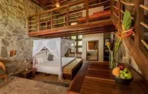 a bedroom with a bed in a room at Villa Aurema a Quiet Nature Retreat in Santa María Tonameca