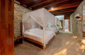 a bedroom with a bed with a canopy at Villa Aurema a Quiet Nature Retreat in Santa María Tonameca