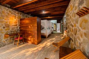 a room with a bedroom with a bed and a bench at Villa Aurema a Quiet Nature Retreat in Santa María Tonameca +106 photos