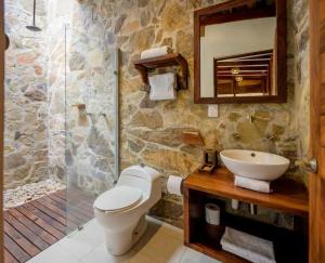 a bathroom with a toilet and a sink and a shower at Casa del Mar AC Rustic design Pool Paceful in Santa María Tonameca +106 photos