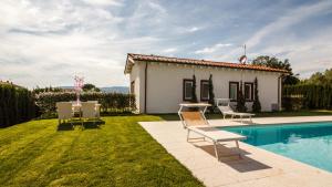 a villa with a pool and a house at Podere Villa Olmo in Pistoia