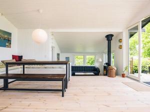 a living room with a bench and a couch at 4 star holiday home in Jægerspris in Jægerspris +22 photos