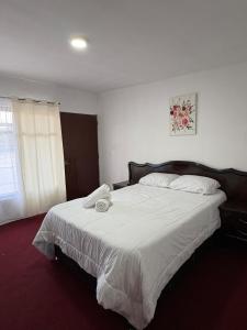 a bedroom with a large bed with white sheets at Comfortable room in Santa María Atlihuetzián