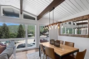 a dining room with a table and a couch at Shadow Mountain 03 in Aspen